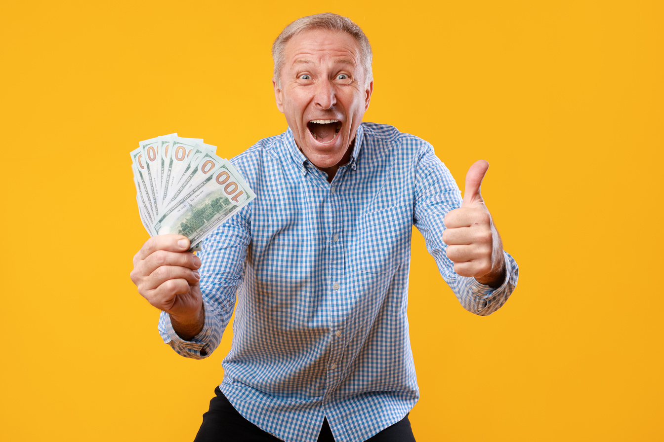 Excited Mature Man Holding a Lot of Money Cash